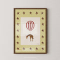 Giraffe Balloon Print - Yellow Star by Nephthys Illustrated, A4 print shown in a dark wood frame