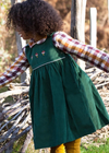 Little Green Radicals green pinafore dress with embroidered mushrooms